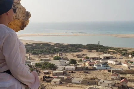 Female tourist exploring the rocky coast of Eyl, Puntland, Somalia