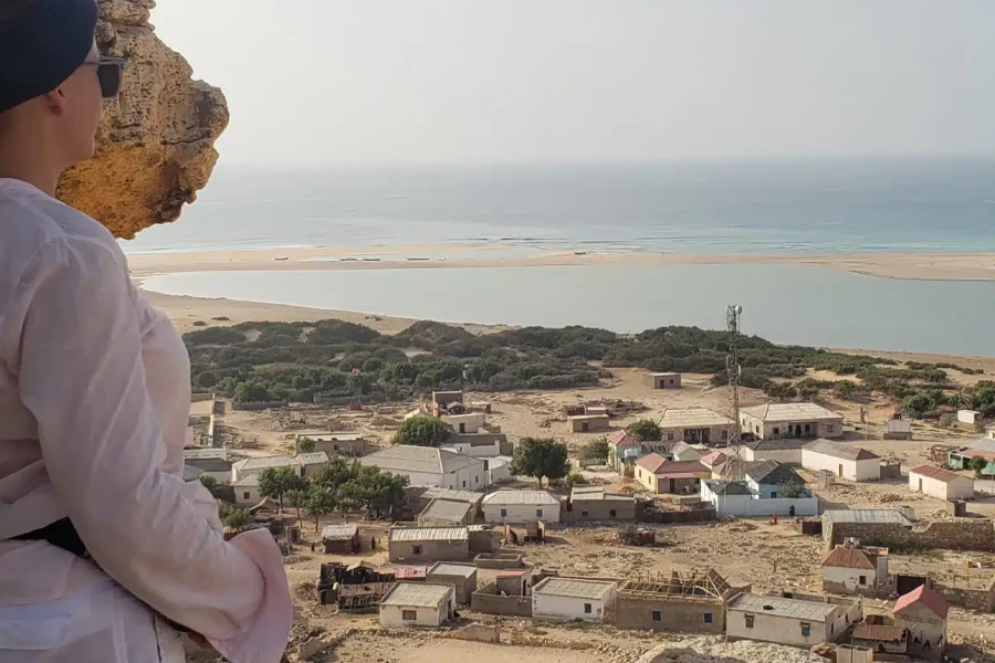 Female tourist exploring the rocky coast of Eyl, Puntland, Somalia